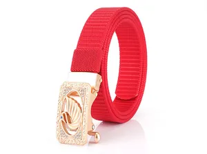 Detailed close-up of a red nylon web belt with a crystal-studded swan buckle