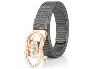 Detail of rose gold automatic buckle with rhinestones on gray woven nylon belt
