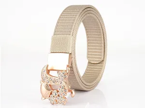 Macro detail of khaki nylon canvas belt with a rose gold rhinestone floral buckle