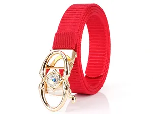 Detail of red nylon belt with golden automatic buckle and colorful crystal inlay