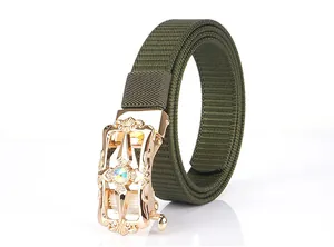 Detailed shot of army green nylon belt with ornate gold buckle and sparkling gem inlay