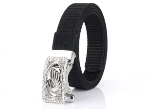 Detailed close-up of a silver swan buckle with intricate floral patterns on a black nylon belt