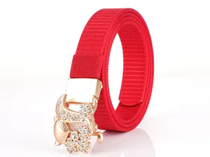 Detail of red nylon belt featuring a gold fox buckle with sparkling rhinestones