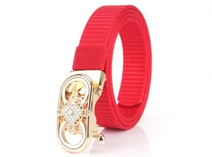 Detail of red nylon belt with gold automatic buckle and sparkling white rhinestones