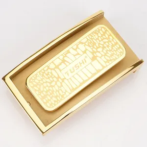 Detail of golden stainless steel automatic belt buckle with textured TUSHI logo panel