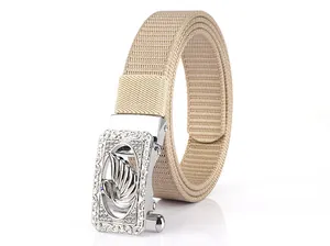 Detail of khaki nylon belt featuring a silver automatic buckle with swan relief and rhinestones