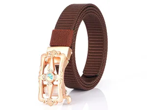 Detailed macro view of dark brown woven nylon belt with rose gold floral gemstone buckle