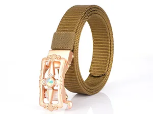 Detail of rose gold automatic buckle with gemstone inlay on khaki nylon canvas belt