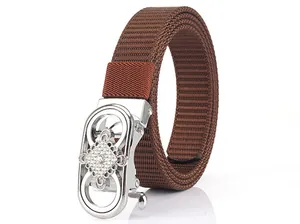 Detail of dark brown nylon belt with silver automatic buckle and rhinestone pattern