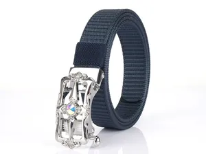 Detail of navy nylon belt featuring an alloy buckle with star pattern and rhinestone