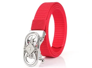 Close-up of red nylon woven belt featuring a silver automatic buckle with white rhinestones