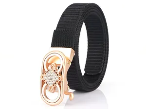 Detail of black nylon belt featuring a rose gold oval buckle with sparkling rhinestones