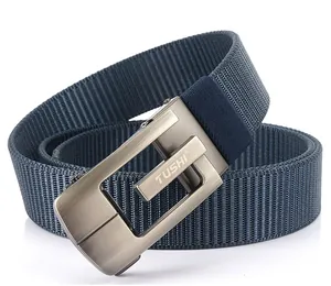 Detail of blue nylon woven belt featuring a brushed metal buckle with TUSHI brand logo