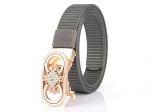 Detail of grey nylon woven belt with rose gold rhinestone floral automatic buckle