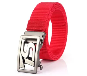Macro detail of red woven nylon belt showing matte gunmetal automatic buckle with S logo