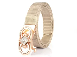 Close-up of beige woven belt with rose gold oval buckle featuring rhinestones