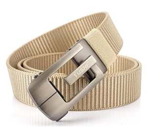 Detail of the khaki nylon belt featuring a brushed metal automatic buckle and woven texture