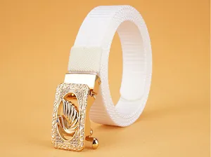 Detail of white nylon belt featuring a gold swan buckle with sparkling rhinestones