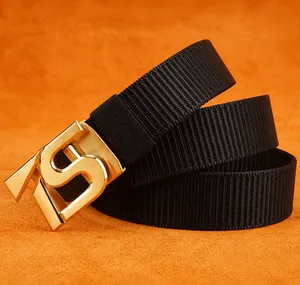 Close-up of black heavy-duty nylon belt with golden matte S-buckle on orange leather base