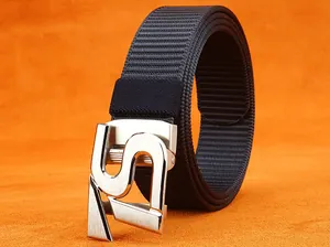 Detail of nylon belt with a brushed silver S-shaped buckle on an orange surface