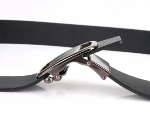 Detail of the gunmetal automatic buckle mechanism and leather texture on a men's belt