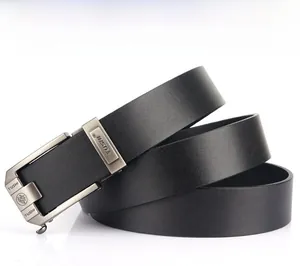 Close-up of black leather belt with matte grey automatic buckle featuring lion crest