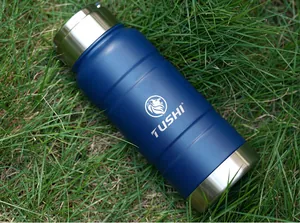 Outdoor tactical 520ML stainless steel vacuum bottle displayed on fresh green grass