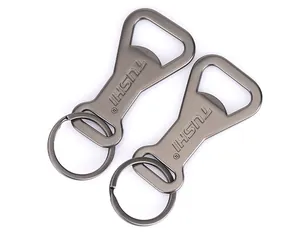 Macro detail of matte gunmetal aluminum alloy bottle opener keychain with engraved logo