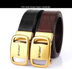 Close-up of men's leather belts with golden automatic buckles and crocodile texture