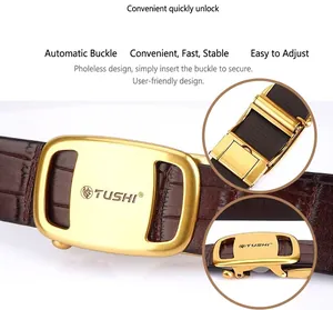 Macro detail of brown leather belt and golden automatic buckle with TUSHI engraving