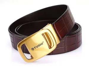 Close-up of golden automatic buckle with lion emblem and dark brown embossed leather belt