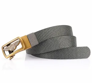Detail of grey nylon belt with golden zinc alloy eagle wing buckle and breathable webbing