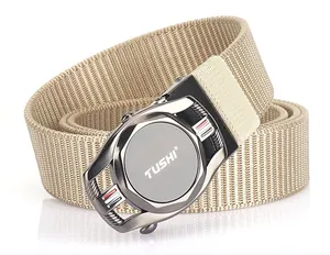Detail of khaki nylon belt strap and matte gunmetal buckle with TUSHI brand logo