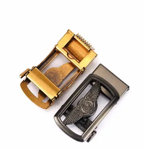 Detail of zinc alloy automatic belt buckles with embossed winged lion logos in gold and gunmetal