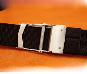 Detail of silver stainless steel buckle on a black woven nylon outdoor sports belt