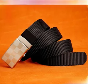 Detail of black nylon woven belt with silver checkerboard pattern slider buckle