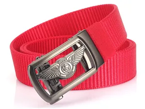 Macro detail of red nylon woven belt with gunmetal lion buckle and textured strap