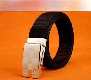Detail of black nylon tactical belt featuring a textured silver automatic metal buckle
