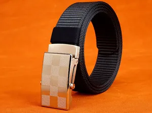 Macro shot of silver automatic buckle with checkered texture and black nylon woven belt