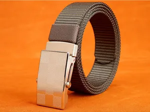 Detail of matte silver slide buckle with grid pattern on a braided nylon belt