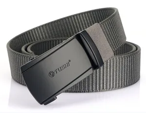 Detail of matte black buckle with wolf logo on gray woven nylon canvas tactical belt
