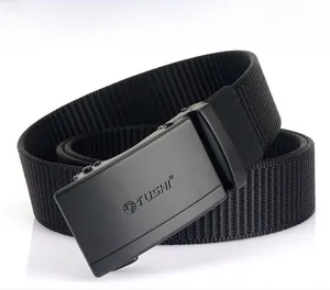 Detail of a black nylon belt featuring a matte metal buckle with a lion head logo