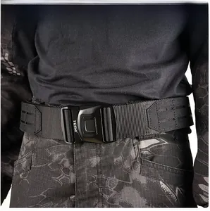 Close-up of tactical belt metal quick-release buckle and Molle system on camouflage gear