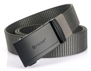 Detail of grey nylon web belt with matte black automatic buckle and lion head logo