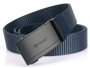 Detail of the navy nylon belt with a matte black automatic buckle and TUSHI logo