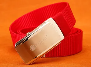 Detail of red nylon belt with brushed silver automatic buckle and lion logo engraving