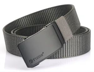 Detailed macro view of the matte black automatic buckle with TUSHI logo on nylon belt