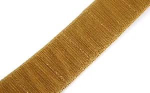 Macro shot of durable khaki hook-and-loop tactical belt strap with dense fiber texture