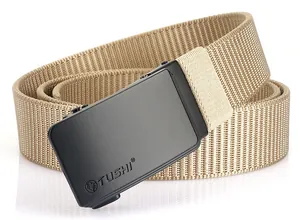 Close-up of tan tactical nylon belt with black matte automatic buckle and lion logo