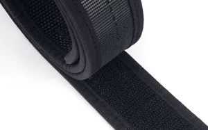 Macro detail of black tactical nylon belt featuring reinforced hook and loop fastener strap